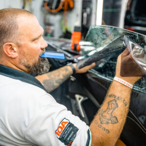 Brian from Summer Breeze Ceramic Coating & Mobile Detailing performing a window tinting installation
