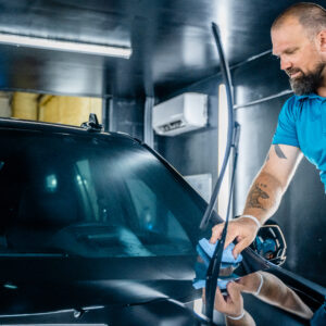 Brian touching up the window area of a car with a fresh, professionally installed layer of ceramic coating