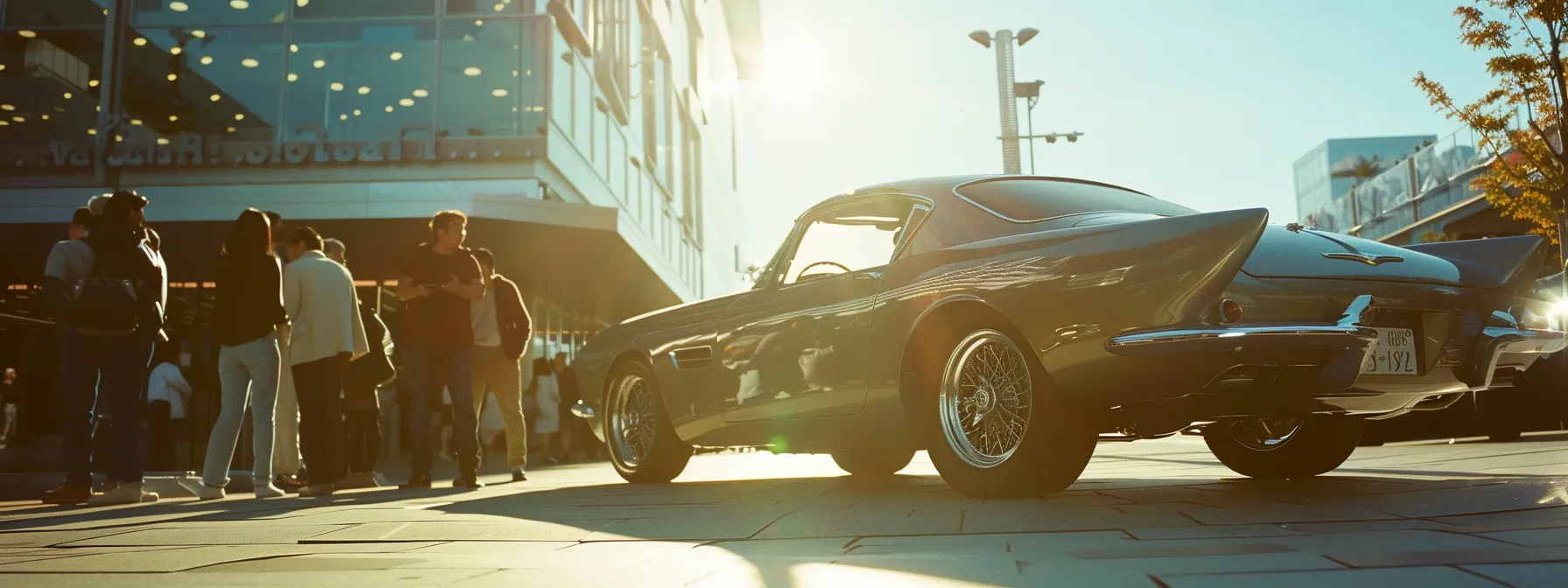 a sleek, shiny car gleaming under the bright sun, surrounded by satisfied customers eagerly examining the immaculate detailing work done by a reputable local auto detailing provider.