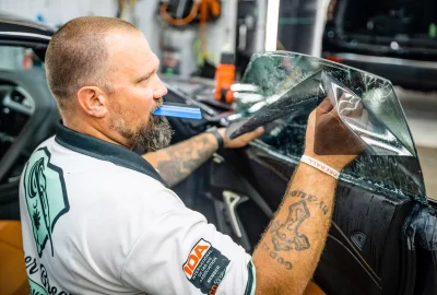 Brian installing black tint on a vehicle