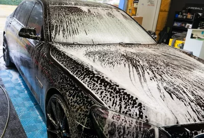 a black vehicle in the process of being exterior detailed