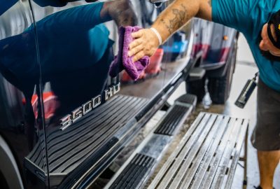 Brian from Summer Breeze Ceramic Coating & Mobile Detailing finishing up a full detailing job on a black pickuo